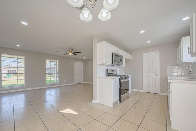 8719 Valley Meadow Dr, Houston, TX 77078 - kitchen featuring light countertops, appliances with stainless steel finishes, light tile patterned flooring, and a sink