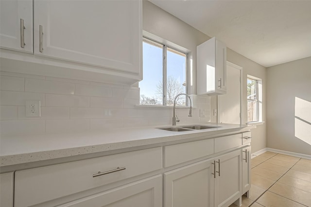 8719 Valley Meadow Dr, Houston, TX 77078 - kitchen featuring white cabinets, tasteful backsplash, and a sink