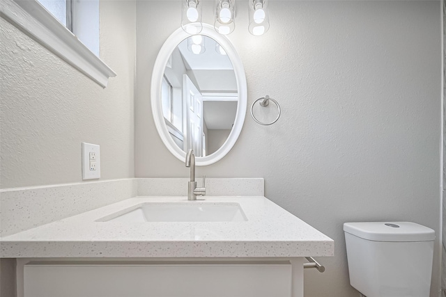 8719 Valley Meadow Dr, Houston, TX 77078 - bathroom with a textured wall, vanity, and toilet