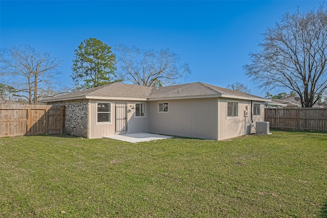8719 Valley Meadow Dr, Houston, TX 77078 - back of property featuring central AC, a fenced backyard, a patio, and a lawn