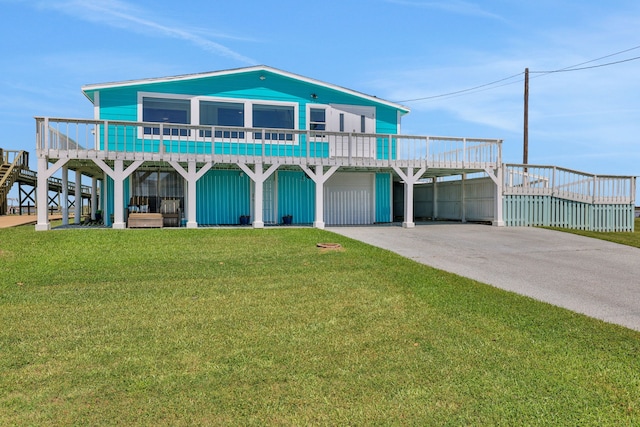 coastal home featuring a front yard, a carport, and concrete driveway