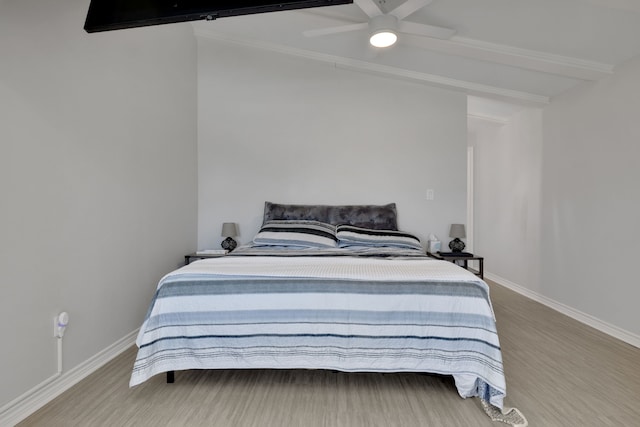 bedroom with beamed ceiling, baseboards, a ceiling fan, and wood finished floors