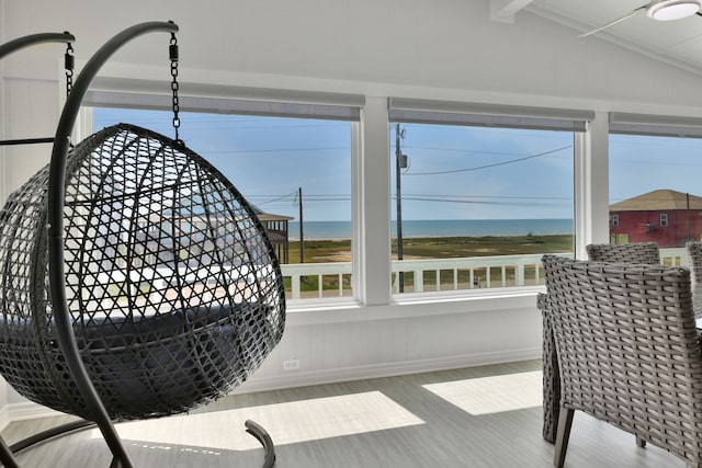 interior details featuring a water view, baseboards, and wood finished floors