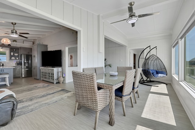 dining room featuring beam ceiling, a ceiling fan, and wood finished floors