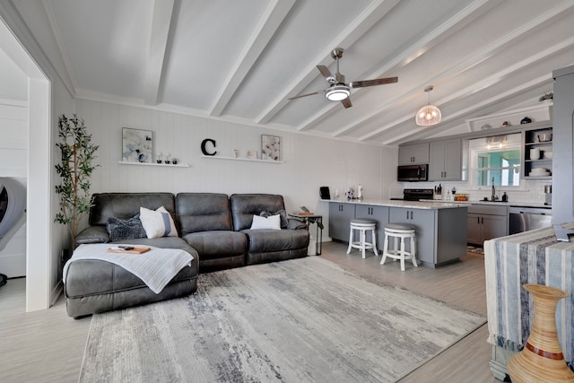 living room featuring light wood-style floors, lofted ceiling with beams, and a ceiling fan