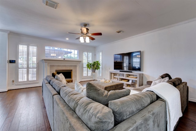 15122 Windsdowne Ln, Cypress, TX 77429 - living room with ornamental molding, dark wood-type flooring, ceiling fan, healthy amount of natural light, and a fireplace