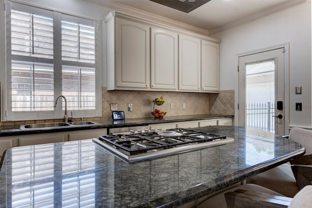 15122 Windsdowne Ln, Cypress, TX 77429 - kitchen featuring crown molding, tasteful backsplash, a kitchen breakfast bar, plenty of natural light, and stainless steel gas stovetop