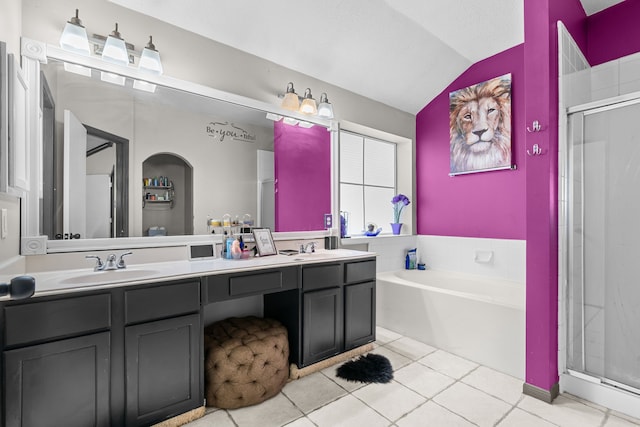 bathroom with lofted ceiling, tile patterned floors, a sink, and a stall shower