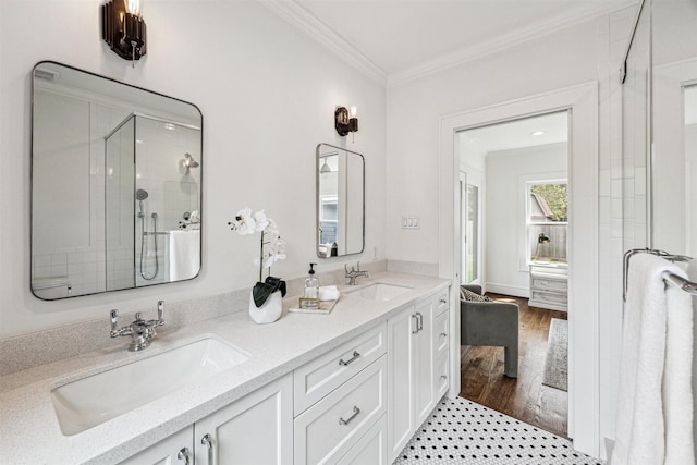 636 Pizer St, Houston, TX 77009 - full bathroom with crown molding, a stall shower, double vanity, and wood finished floors
