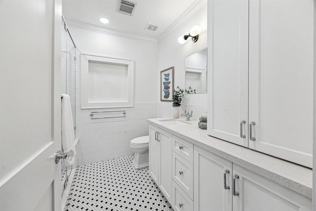 636 Pizer St, Houston, TX 77009 - bathroom featuring crown molding, toilet, double vanity, tile walls, and a shower
