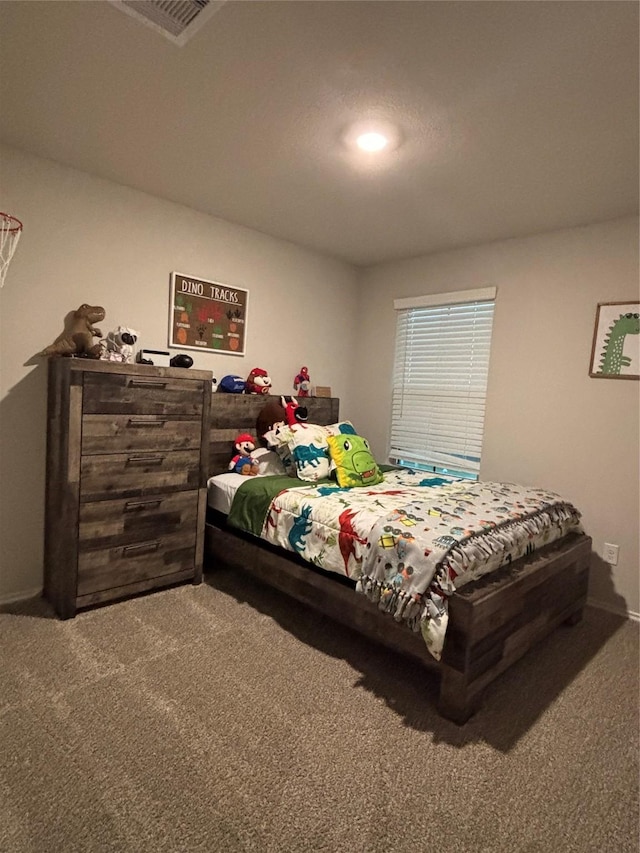 bedroom with baseboards, visible vents, and carpet