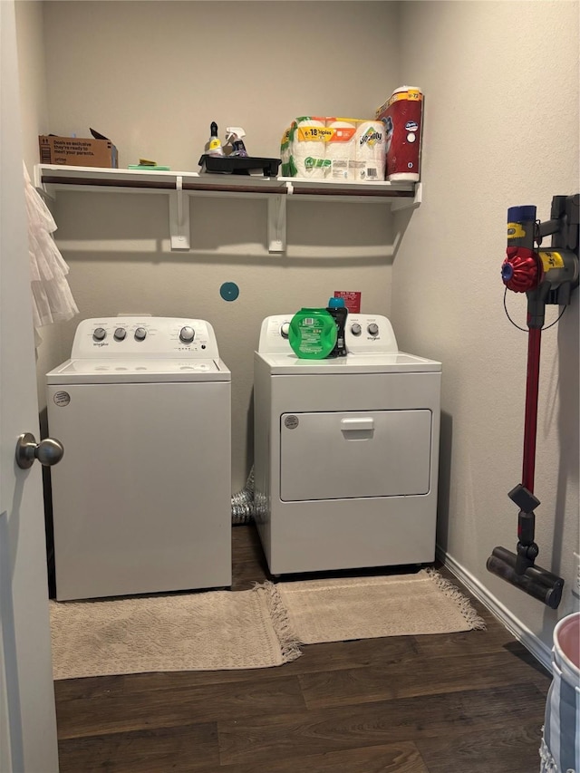 laundry area with wood finished floors, independent washer and dryer, laundry area, and baseboards