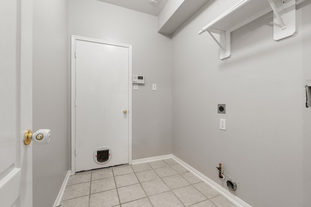 clothes washing area featuring light tile patterned floors, baseboards, hookup for a gas dryer, laundry area, and hookup for an electric dryer