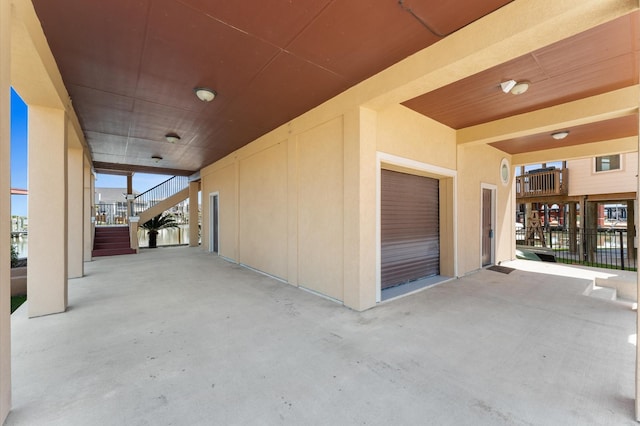 view of patio with stairway and a garage