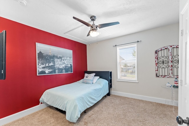 carpeted bedroom featuring a ceiling fan and baseboards