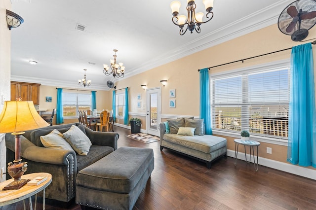 living area with a chandelier, ornamental molding, wood finished floors, and baseboards