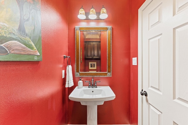 bathroom featuring a textured wall
