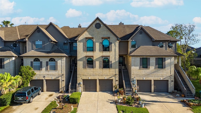 2729 Lighthouse Dr, Houston, TX 77058 - multi unit property featuring brick siding, driveway, stairway, and a garage