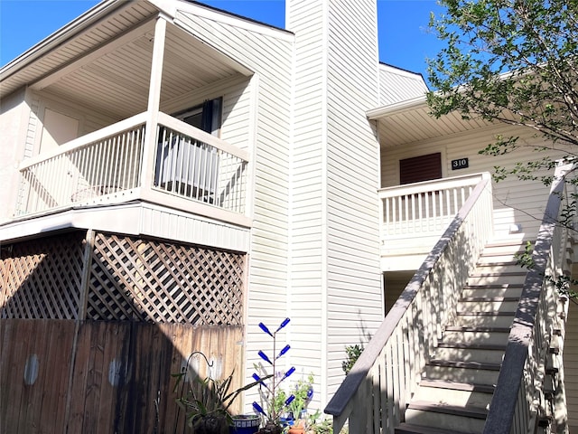 7600 Emmett F Lowry Expy Unit 310, Texas City, TX 77591 - view of property exterior with stairs and a chimney