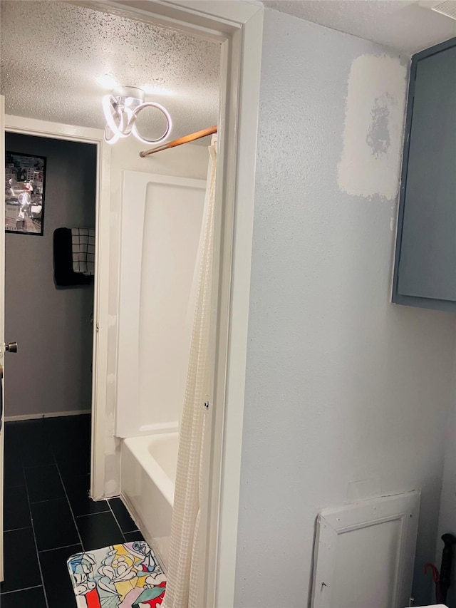 7600 Emmett F Lowry Expy Unit 310, Texas City, TX 77591 - full bathroom with tile patterned floors, a textured ceiling, and shower / bath combination with curtain