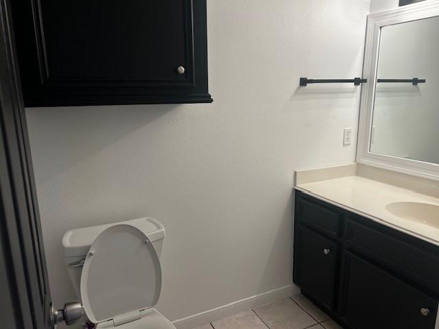 4027 N Fm 565th Rd, Mont Belvieu, TX 77523 - bathroom with tile patterned floors, vanity, toilet, and baseboards