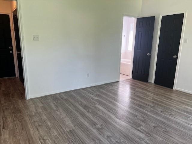 4027 N Fm 565th Rd, Mont Belvieu, TX 77523 - spare room with wood finished floors and baseboards