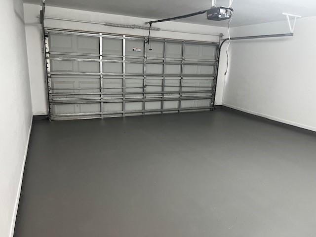 4027 N Fm 565th Rd, Mont Belvieu, TX 77523 - garage with a garage door opener and baseboards