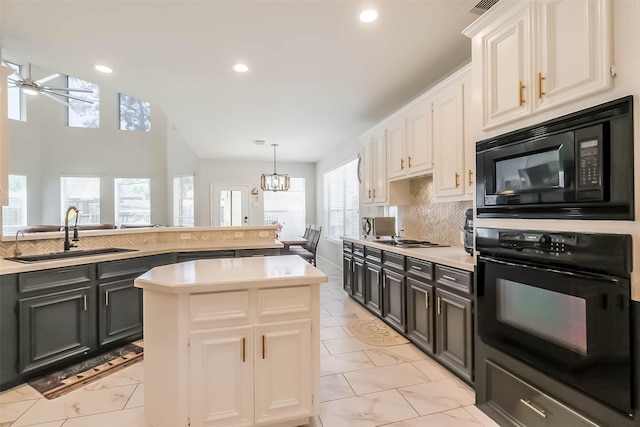 7015 Timber Edge Ln, Humble, TX 77346 - kitchen featuring black appliances, a sink, light countertops, tasteful backsplash, and recessed lighting