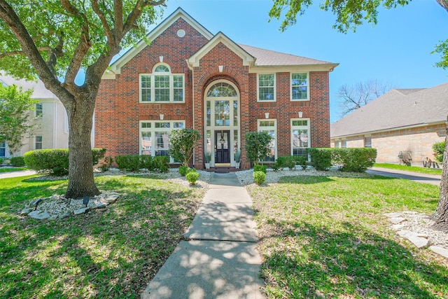 7015 Timber Edge Ln, Humble, TX 77346 - traditional-style house with brick siding and a front yard