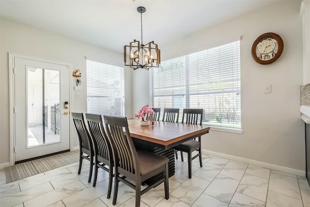 7015 Timber Edge Ln, Humble, TX 77346 - dining room featuring light marble finish flooring, healthy amount of natural light, a chandelier, and baseboards