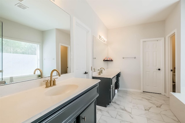 7015 Timber Edge Ln, Humble, TX 77346 - full bathroom featuring two vanities, a tub to relax in, and marble finish flooring