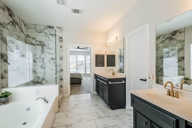 7015 Timber Edge Ln, Humble, TX 77346 - ensuite bathroom with two vanities, a garden tub, a ceiling fan, a walk in shower, and marble finish floors