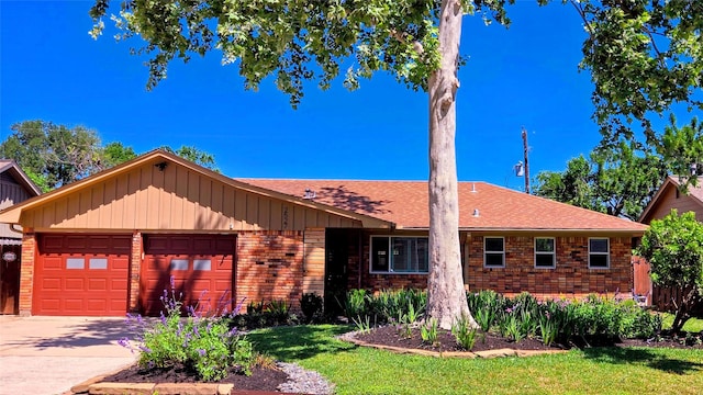 single story home with driveway, a front yard, a garage, brick siding, and a shingled roof