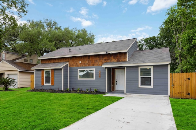 3806 Zephyr St, Houston, TX 77021 - view of front facade with a front lawn, fence, a shingled roof, and concrete driveway