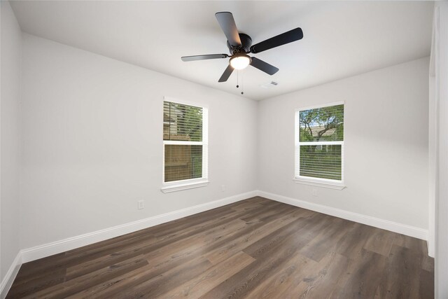 3806 Zephyr St, Houston, TX 77021 - spare room featuring ceiling fan, dark wood-style flooring, baseboards, and visible vents