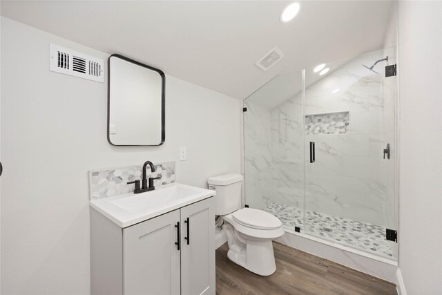 3806 Zephyr St, Houston, TX 77021 - full bathroom with vanity, visible vents, toilet, wood finished floors, and a marble finish shower