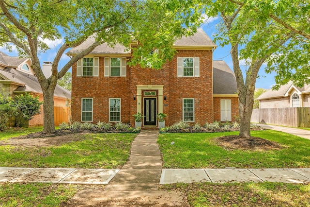 view of front of home featuring brick siding and a shingled roof