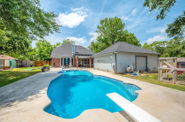 view of swimming pool with an outdoor structure, a patio, a fenced backyard, a fenced in pool, and a yard