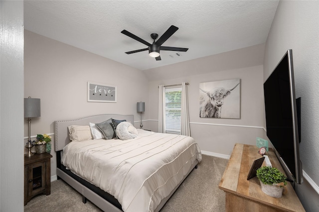 bedroom featuring a textured ceiling, carpet, a ceiling fan, baseboards, and visible vents