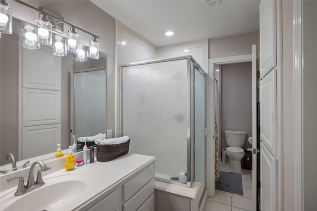full bathroom with toilet, a shower stall, tile patterned flooring, and vanity