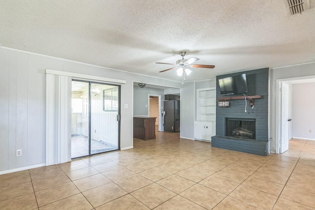 unfurnished living room with ceiling fan, visible vents, light tile patterned flooring, a brick fireplace, and built in shelves