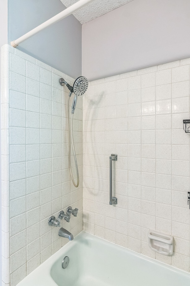 bathroom featuring bathing tub / shower combination and a textured ceiling