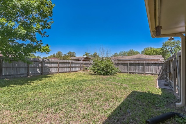 view of yard with a fenced backyard