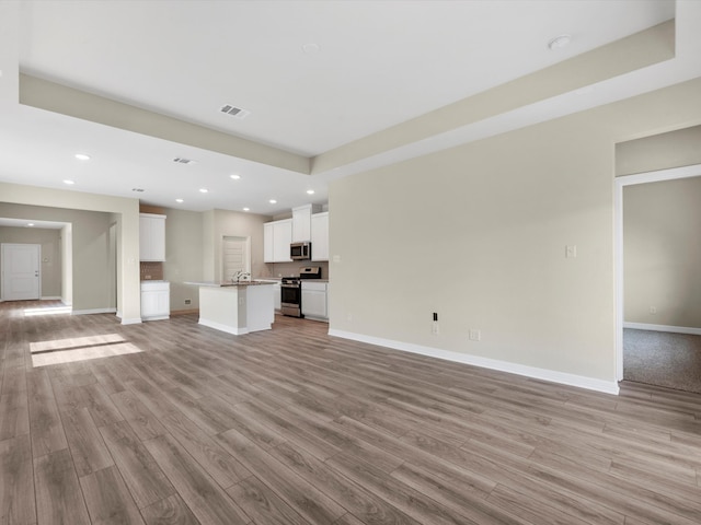 7602 Magnolia Orchid Ln, Cypress, TX 77433 - unfurnished living room with light wood-style floors, baseboards, visible vents, and recessed lighting