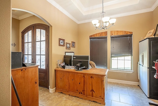 office space with a tray ceiling, arched walkways, a notable chandelier, and a healthy amount of sunlight
