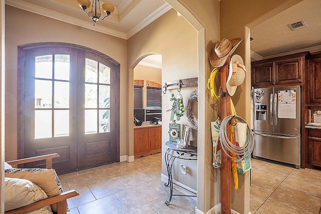 foyer with arched walkways, french doors, visible vents, and a healthy amount of sunlight