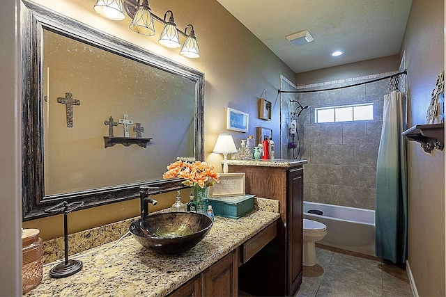 full bathroom featuring toilet, shower / bath combo, vanity, and tile patterned floors