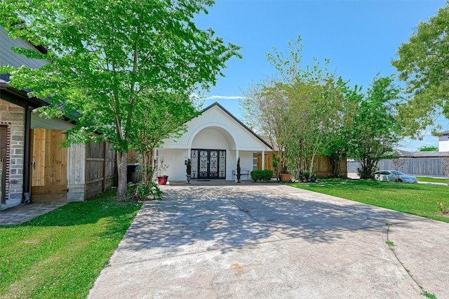 1265 Du Barry Ln, Houston, TX 77018 - view of front of property with concrete driveway, stucco siding, french doors, a front yard, and fence