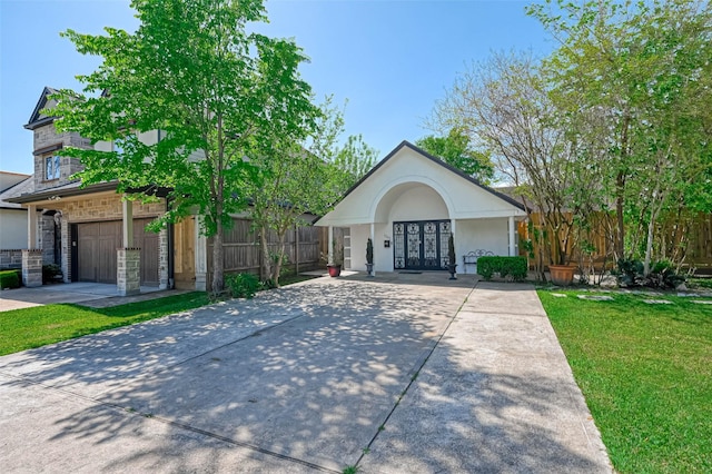 1265 Du Barry Ln, Houston, TX 77018 - view of front facade featuring a garage, stucco siding, french doors, a front lawn, and driveway