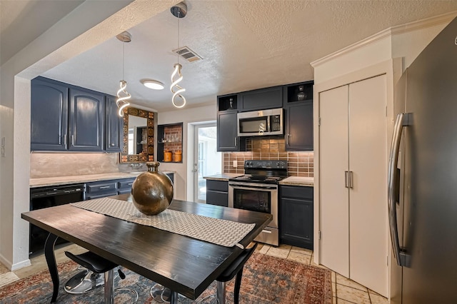 1265 Du Barry Ln, Houston, TX 77018 - kitchen featuring light countertops, backsplash, visible vents, and stainless steel appliances